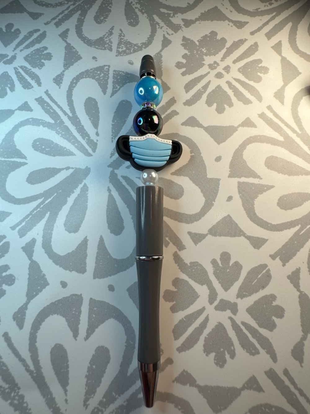 Gray Beaded Ballpoint Pen with Blue Mask Charm